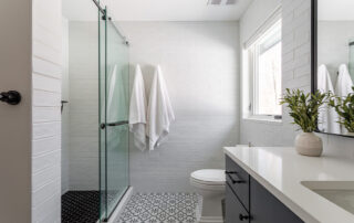 Modern walk-in shower with frameless glass enclosure in a Rhode Island bathroom remodel