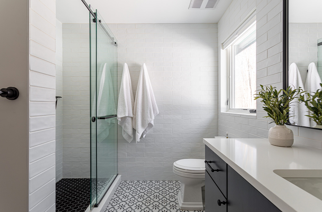 Modern walk-in shower with frameless glass enclosure in a Rhode Island bathroom remodel
