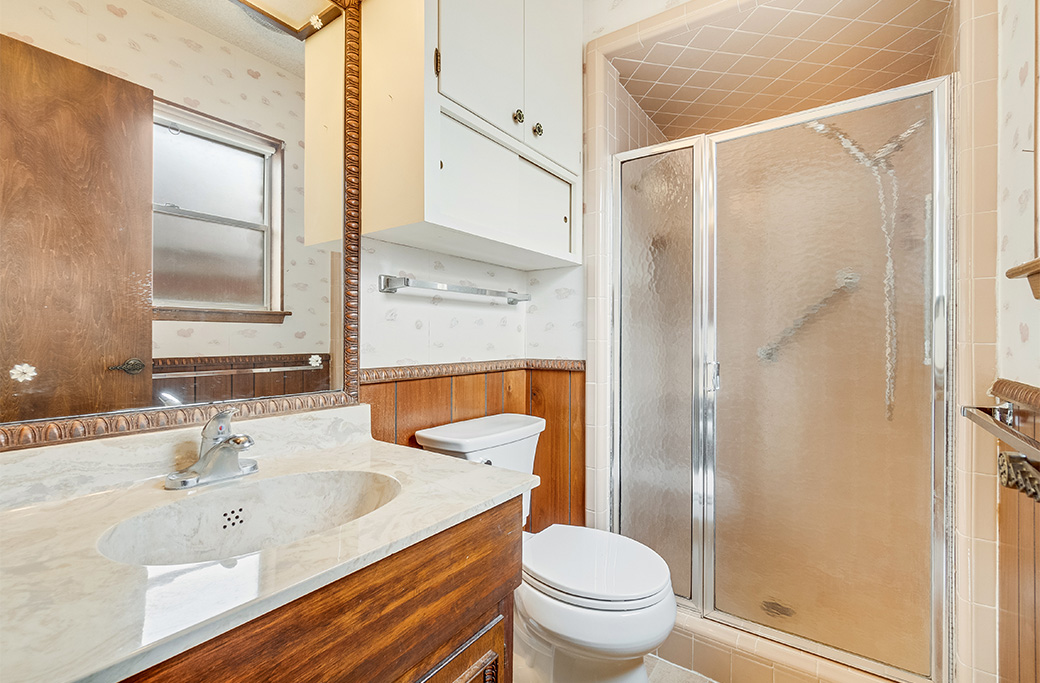 Outdated bathroom layout before remodeling in a Rhode Island home