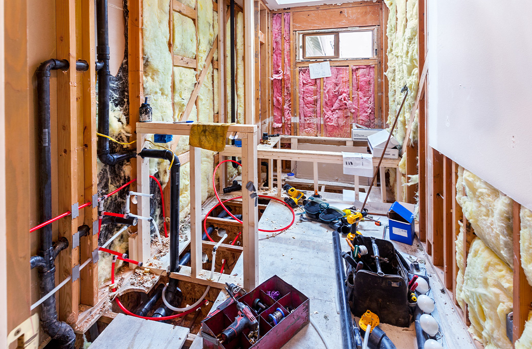Bathroom renovation in an older Rhode Island home showing plumbing behind the walls