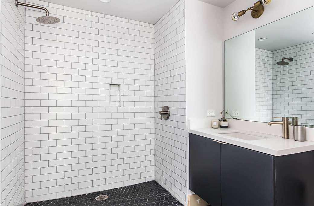 Walk-in shower with custom tile walls and shower floor in a Rhode Island bathroom