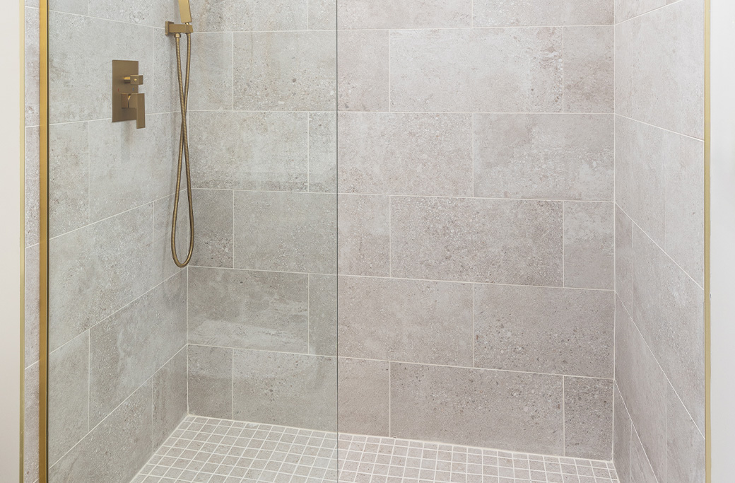 Large-format bathroom tile creating fewer grout lines in a walk-in shower