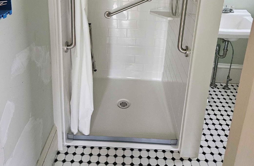 Small bathroom remodel in Tiverton, Rhode Island home with space-saving fixtures and storage