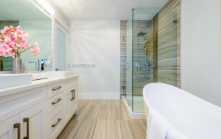 Modern bathroom remodel in Cranston Rhode Island featuring a walk-in shower, tile walls, and custom vanity