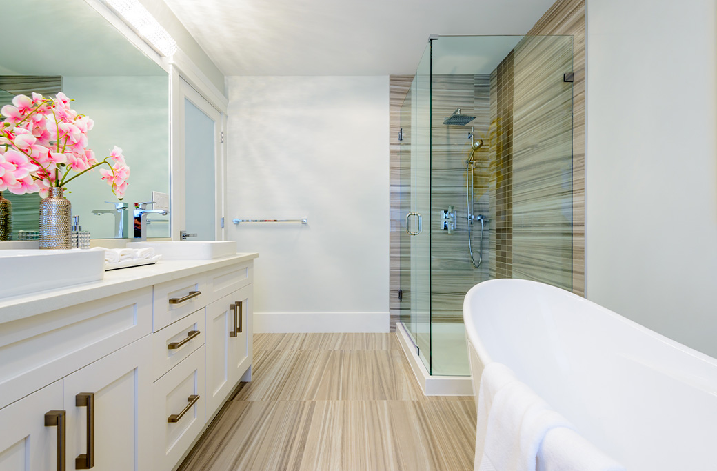 Modern bathroom remodel in Cranston Rhode Island featuring a walk-in shower, tile walls, and custom vanity