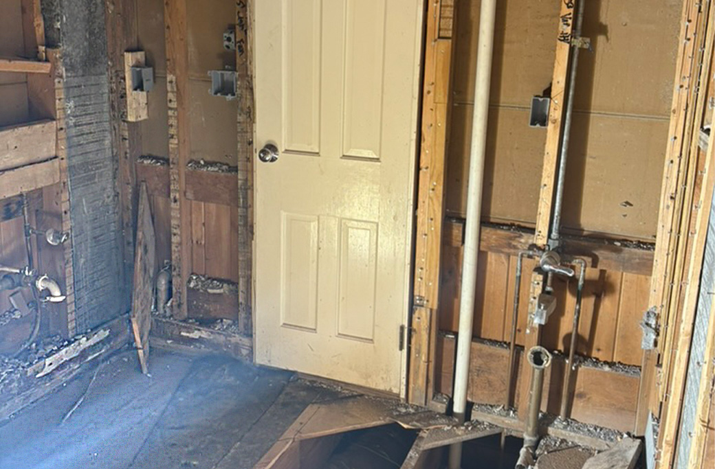 Bathroom wall opened during renovation to inspect plumbing in a Rhode Island home